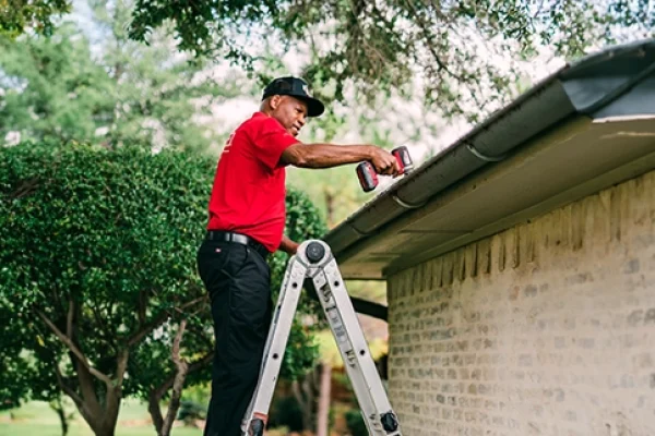 professional gutter cleaning Auckland technician on ladder